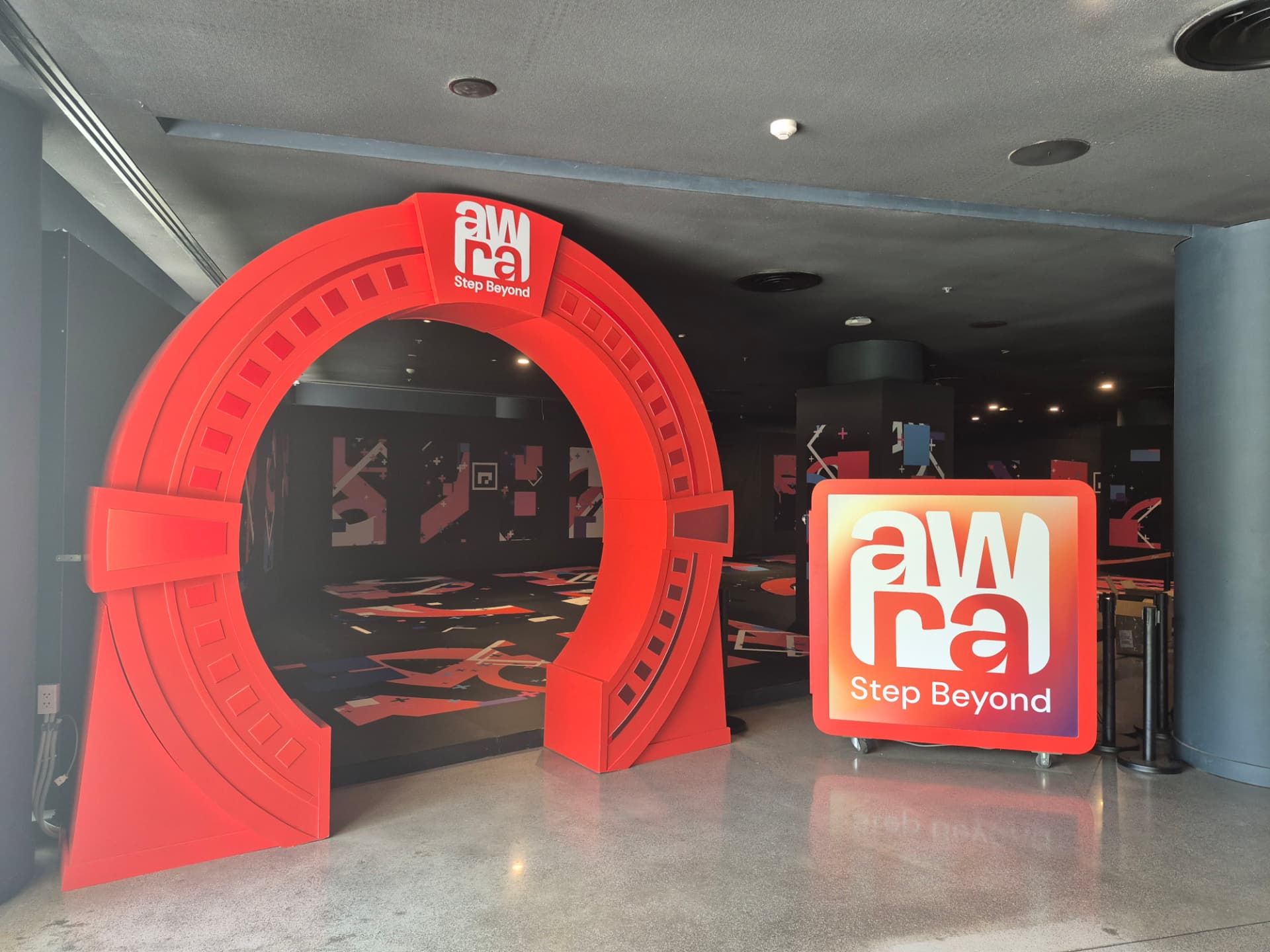 Awra's red arch entrance and illuminated "Step Beyond" sign