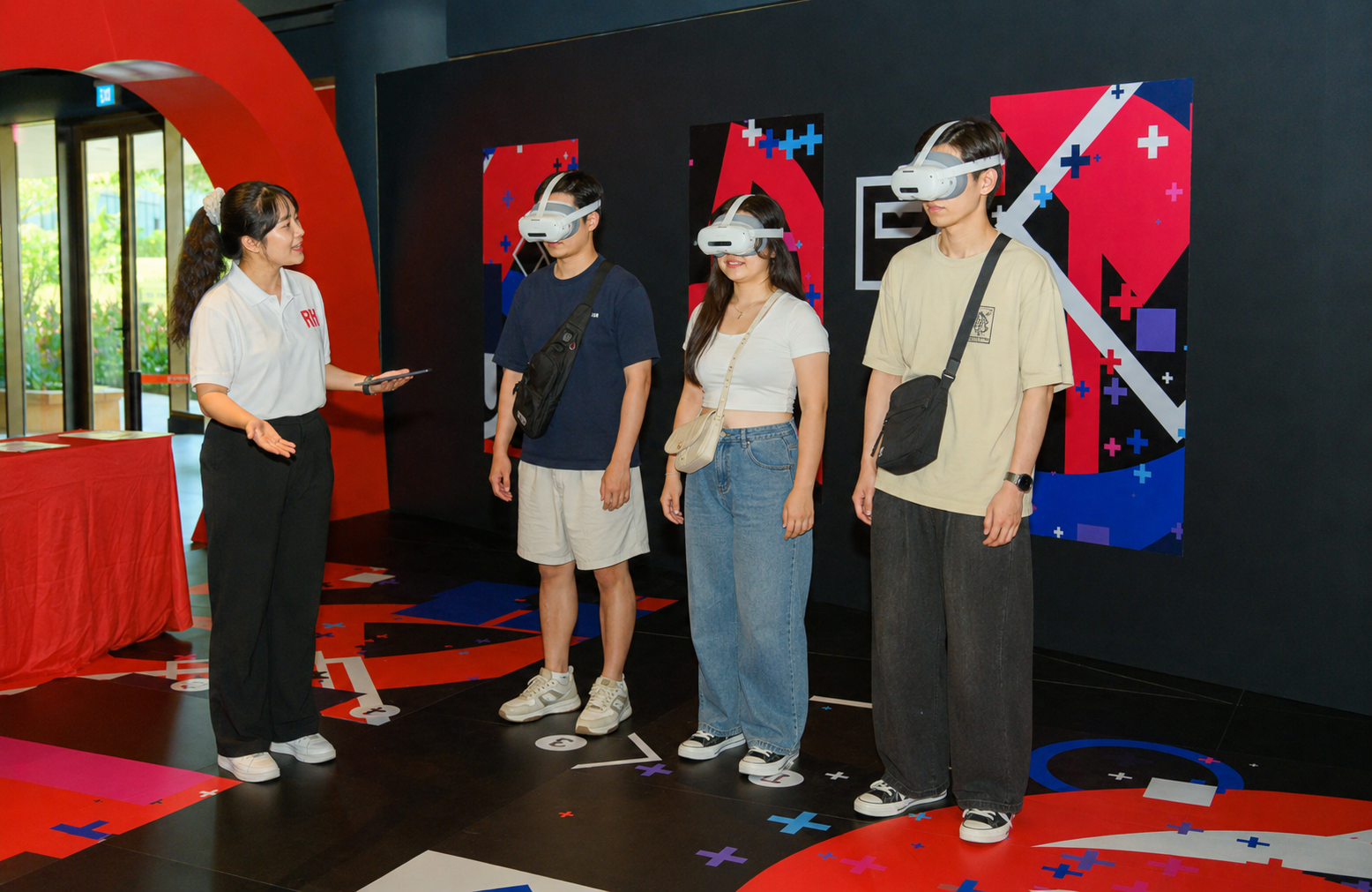 An Awra team member guiding three guests wearing VR headsets during onboarding