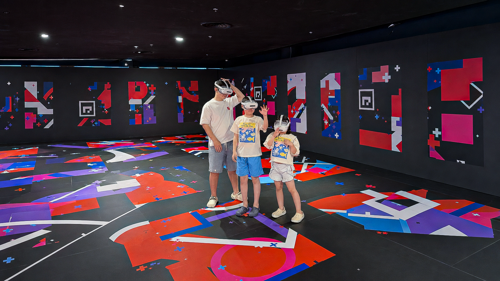 A family wearing VR headsets inside Awra's walk-through play area at Alma Resort Cam Ranh